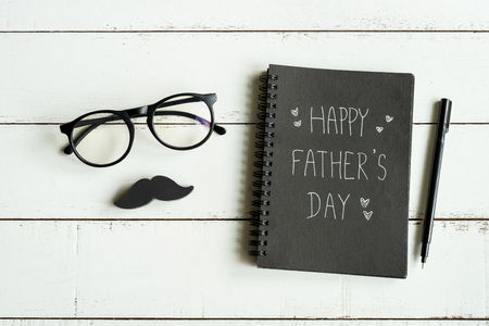 Happy Father's Day message on notebook with white baackgroundの写真素材