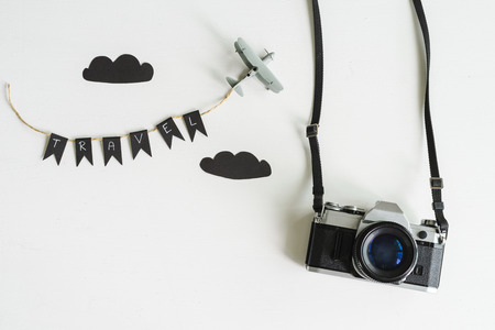 Retro camera with airplane toy on white background, Top view, Travel conceptの写真素材