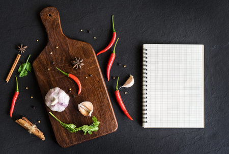 Selection of spices herbs and Ingredients for cooking. Food background with empty notebook and copy space, Top viewの写真素材
