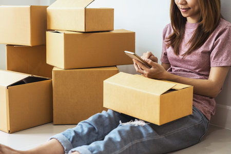 Young asian woman working online business by using smart phone, Online business owner concept