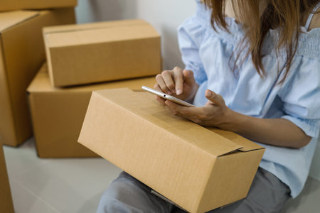 Young asian woman working online business by using smart phone, Online business owner concept