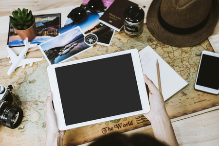 Young woman planning vacation trip and searching information or booking hotel on a tabletの写真素材