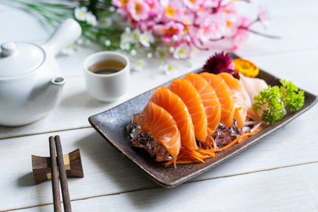 Salmon sashimi slice fresh serve on ice with tea, Japanese styleの写真素材