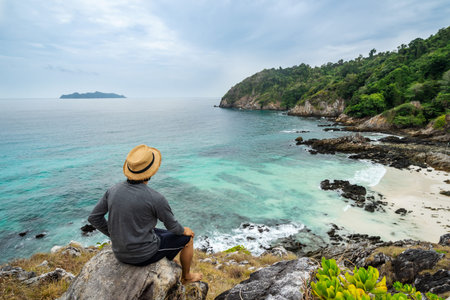 Young traveler looking beautiful seascape view at cock burn Island in Myanmar, Summer vacation and...