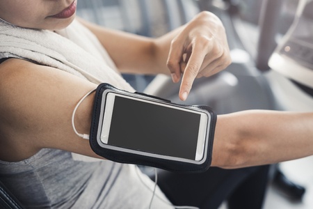 Young sport woman in gym using smartphone, Fitness ,training lifestyle conceptの写真素材