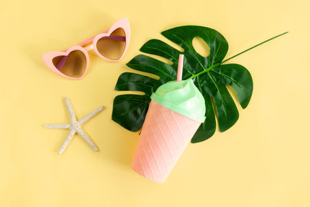 Fancy glass with heart shape sunglasses on pastel colors background, Summer concept