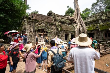 Siem Reap, Cambodia - July 28, 2018: Tourist visiting in Ta Prohm at Angkor Wat complex, Chinese tour group sightseeing. Khmer architecture heritage in Siem Reap, Cambodiaのeditorial素材