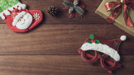 Christmas gifts, ornaments and decorations collection on wooden background with copy space, Flat lay, Top viewの写真素材