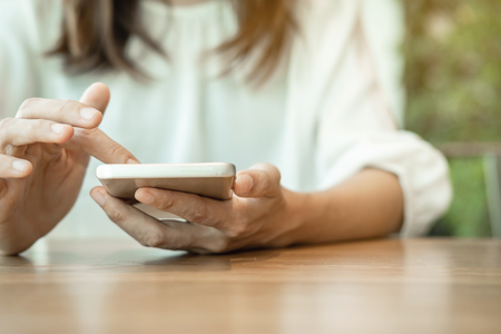 Young woman surfing internet on her smartphoneの写真素材
