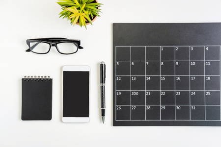 Planning calendar with smartphone on business desk office, Top viewの写真素材