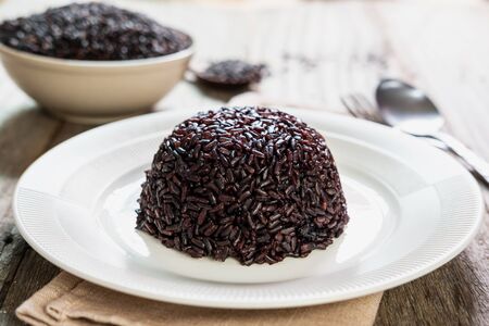 Close up of rice berry on white wooden tableの写真素材