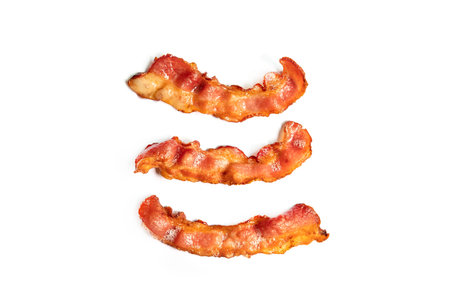 Crispy fried bacon isolated on white backgroundの写真素材