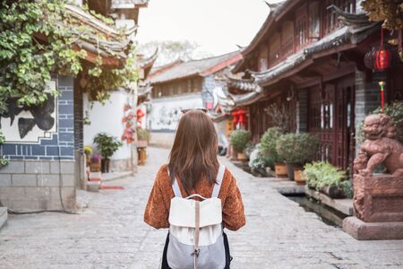 Young woman traveler walking at lijiang old town in China, Travel lifestyle conceptの写真素材