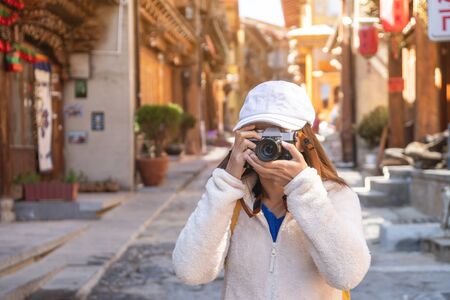 Young woman traveler walking in the old town, Shangri-la, Travel lifestyle conceptの写真素材