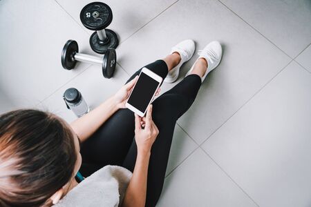 Young sport woman using smart phone in gym, Fitness ,training lifestyle conceptの写真素材