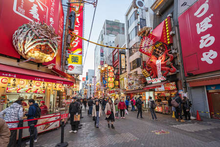 Osaka, Japan - February 06, 2020: Crowd of people walking in night shopping street at Dotonbori, the famous tourist destination in Osaka, Japanのeditorial素材
