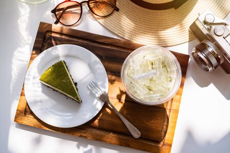 Dessert and drinks with travel items on the tableの写真素材