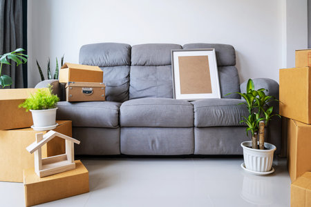 Stack of cardboard boxes in living room at new house on moving day