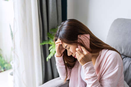 Young depressed and stressed woman crying and having serious conversation at home, Negative emotion and mental health conceptの写真素材