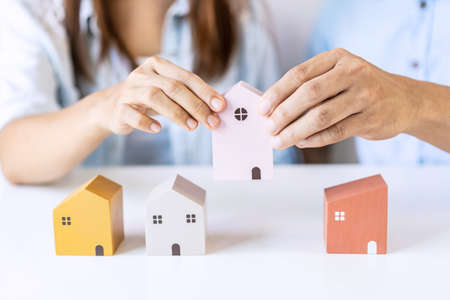 Young couple planning and looking for comparison information on their decision to buy a new home togetherの写真素材