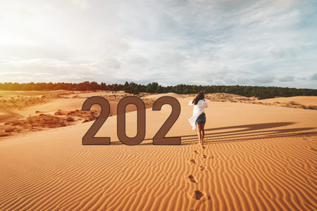 Young woman traveler walking at red sand dunes in Vietnam, 2021 Travel lifestyle concept