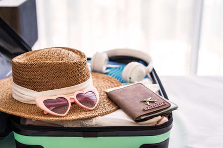 Traveler suitcase and luggage with travel accessories and items ready for travelの写真素材