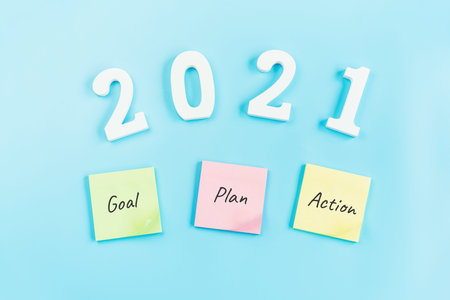 2021 Goal, plan and action sticky notes on color background, Top view with copy space