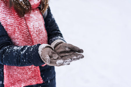 Young woman traveler enjoying with snowfall in winter