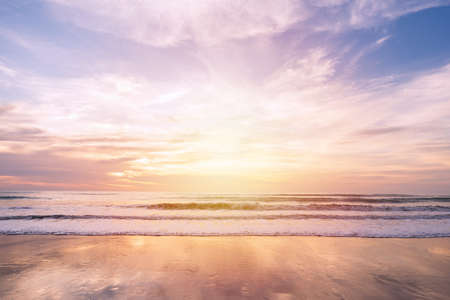 Beautiful sunset over the sea at tranquil tropical beach in summerの写真素材
