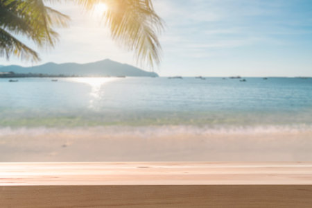 Beautiful tropical sand beach with empty wooden table and copy space, Summer vacation concept