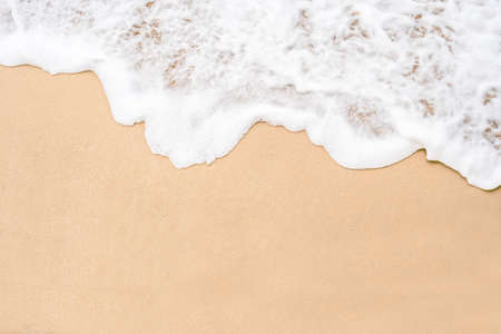Soft ocean wave on tropical sandy beach in summer background with copy spaceの写真素材