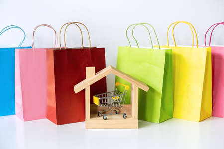 Colorful paper shopping bags on white table, Online shopping at home conceptの写真素材
