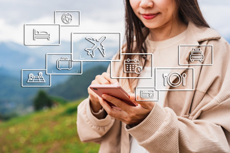 Young woman traveler using smartphone for planning a trip, flight booking and find travel information on summer vacationの写真素材
