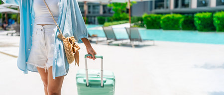 Young woman traveler enjoying a summer vacation at swimming pool in tropical resort near the beach, Travel lifestyle conceptの写真素材