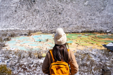 Young happy female traveler enjoying at Huanglong National Park in Sichuan, China