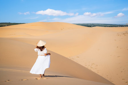 Young woman traveler enjoying at white sand dunes in Vietnam, Travel lifestyle conceptの写真素材