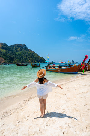 Young Asian woman relaxing and enjoying at beautiful white sand beach in Krabi Thailand, Travel on summer vacationの写真素材