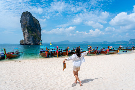 Young Asian woman relaxing and enjoying at beautiful white sand beach in Krabi Thailand, Travel on summer vacationの写真素材