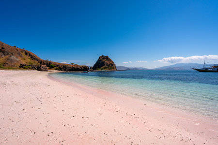 Tropical pink sandy beach with clear turquoise water at Komodo islands in Indonesiaの写真素材