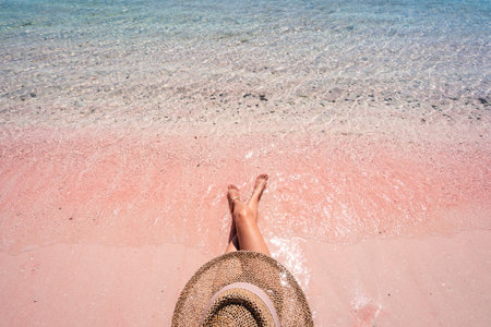 Young female tourism enjoying the tropical pink sandy beach with clear turquoise water at Komodo islands in Indonesiaの写真素材