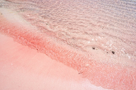Tropical pink sandy beach with clear turquoise water at Komodo islands in Indonesiaの写真素材