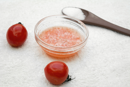 Tomato scrub made out of fresh tomato, sugar and coconut oilの写真素材