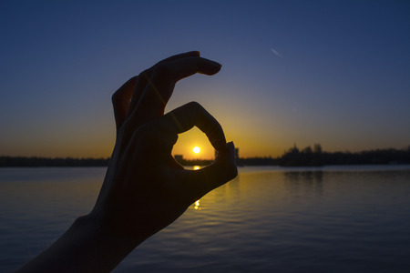 Hand sign saying it's ok in the park Herastrau in Bucharest, Romania.の写真素材
