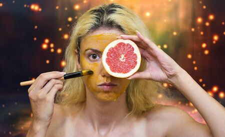 Woman using a homemade mask for oily skin with grapefruit, yolk and honeyの写真素材