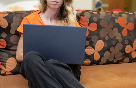 Blonde, attractive woman working from home on the laptop