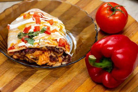Close up on a juicy burrito from a mexican meal