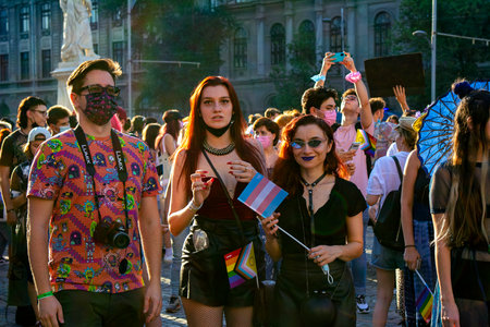 14.08.2021 Romania - Bucharest. Friends waiting for others at the University while attending the lgbt, pride parade with rainbow flags and colored clothing.のeditorial素材