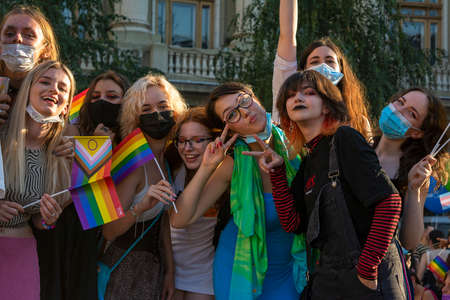 14.08.2021 Romania - Bucharest. Friends waiting for others at the University while attending the lgbt, pride parade with rainbow flags and colored clothing.のeditorial素材