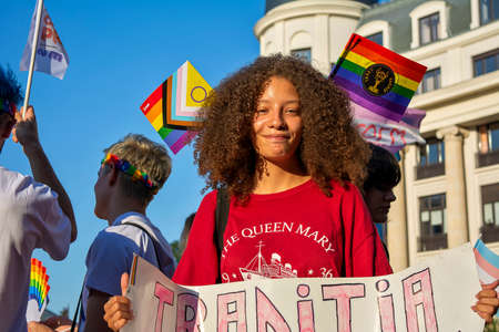 14.08.2021 Romania - Bucharest. A lovely person smiling and holding the banner "Our  tradition is love" on the stage at the University, at the lgbt, pride parade.のeditorial素材