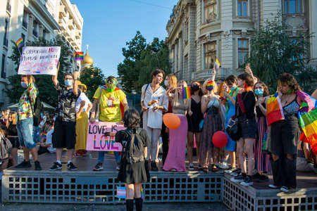 14.08.2021 Romania - Bucharest. People up on the stage an d holding the banners " Love is love" and "Corporations don't represent our interests" at the lgbt, pride parade.のeditorial素材